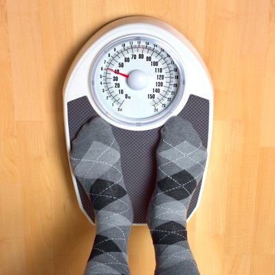 Male anorexic weighing himself