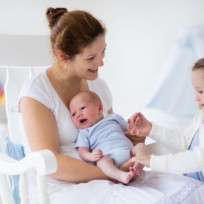 Mother with newborn baby and toddler daughter