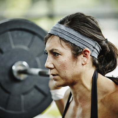 Woman preparing to press barbell overhead