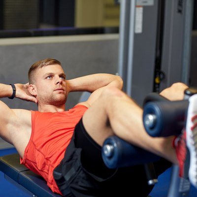 young man making abdominal exercises in gym