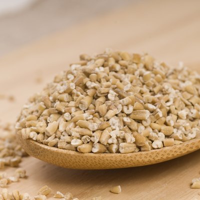 Steel cut oats on a wooden spoon
