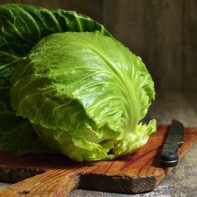 Cabbage head on cutting board.