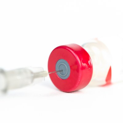 Injection preparation with vial and syringe on white