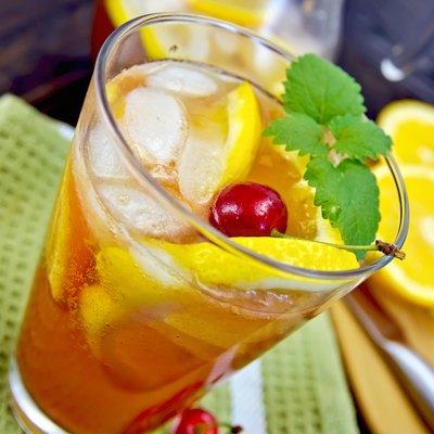 Lemonade with cherry in glassful on board