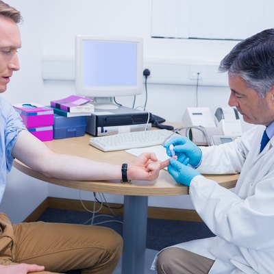 Doctor testing his patients blood