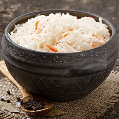 Sauerkraut with carrot in wooden bowl