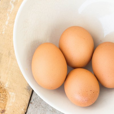 chicken eggs on towel and bowl