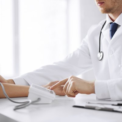 doctor and patient measuring blood pressure