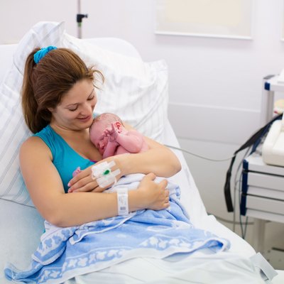 Young mother giving birth to a baby
