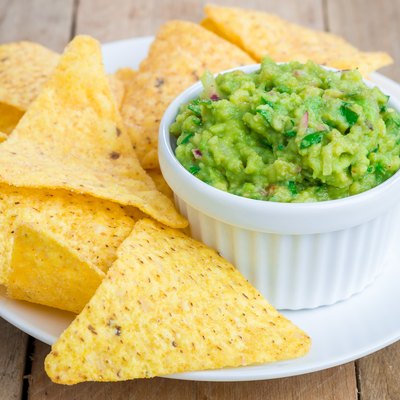 Cup with chunky guacamole served with nachos