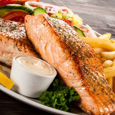 Roasted salmon, French fries and vegetables