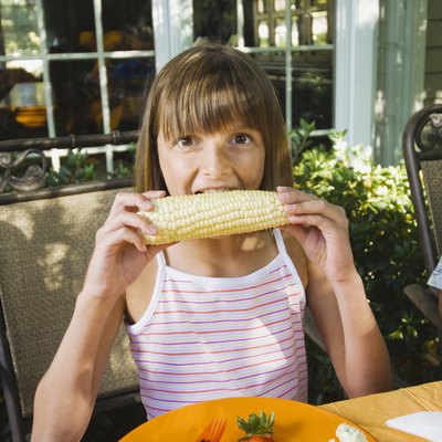 Girl eating corn on the cob