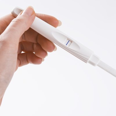 Woman holding pregnancy test