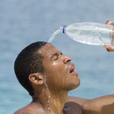 Hispanic man pouring water over head