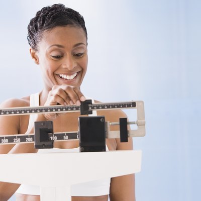 African American woman weighing self