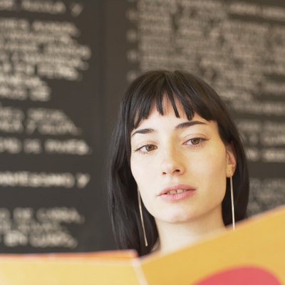Portrait of a young woman holding a mobile phone