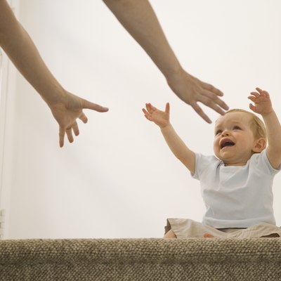 Crying baby reaching for mother