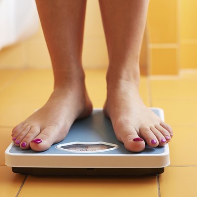 Pair of female feet on a bathroom scale