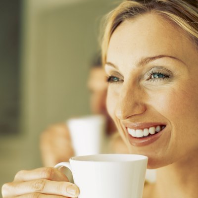 close-up of a mid adult woman drinking a cup of tea