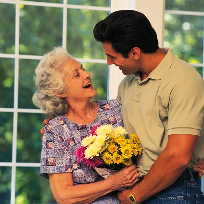 Son bringing flowers to his mother