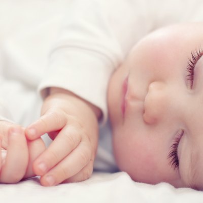 close-up portrait of a beautiful sleeping baby on white