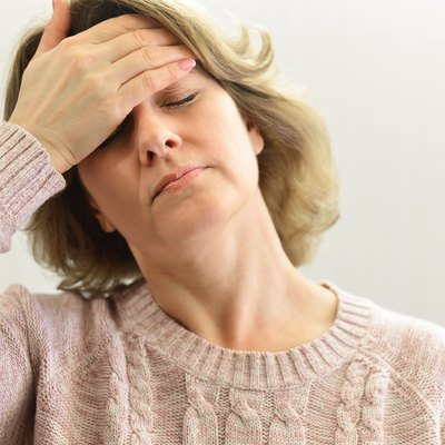 Woman holding hands on head, depression, pain, migraine