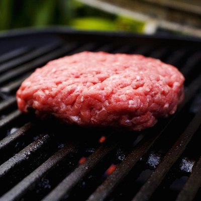 Barbecue scene, hamburger patty on the grill.