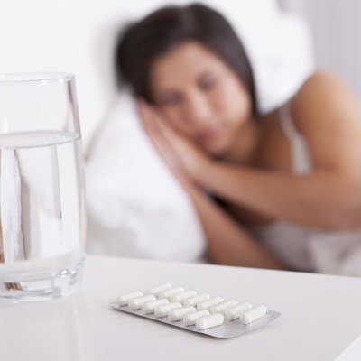 Sick woman resting in bed