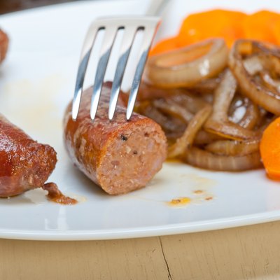 beef sausages cooked on iron skillet