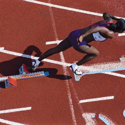 Female runner leaving starting blocks