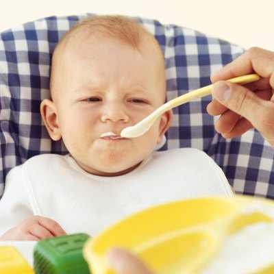 Close-up of father feeding baby boy (6-12 months)