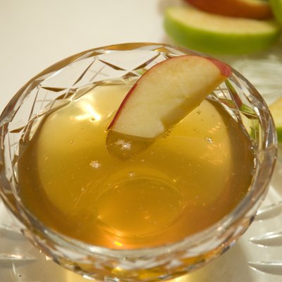 Apple slice in bowl of honey