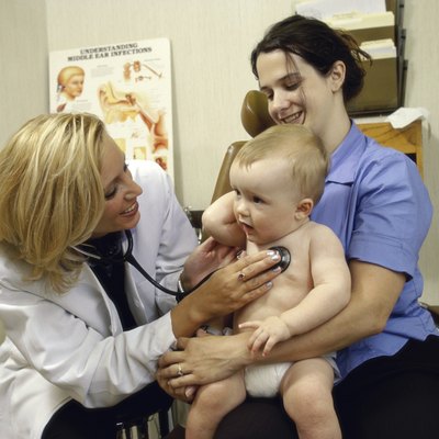 Female doctor examining a baby boy
