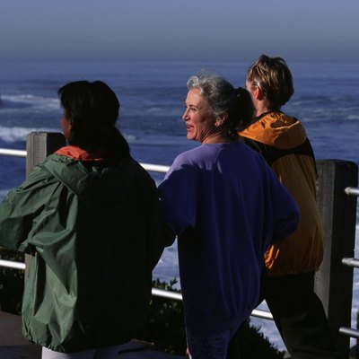 Three women walking along pier