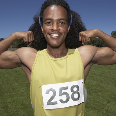 Male track athlete flexing biceps