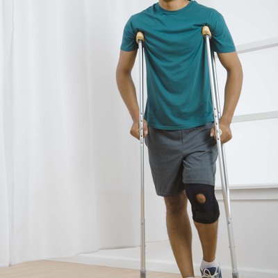 Man with knee brace and crutches