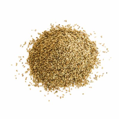 Pile of whole celery seeds on white