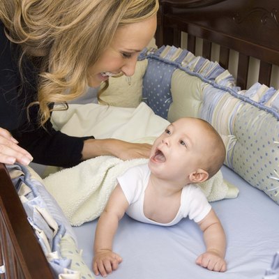 Mother talking to son in crib