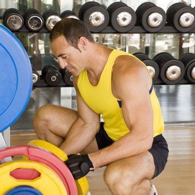 Man adjusting weights