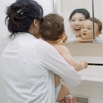 Mother and son looking in mirror