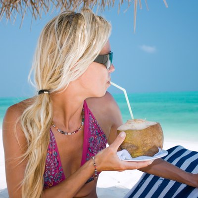 Beautiful blondy holding coconut