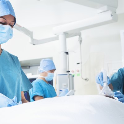 Team of surgeons working with a patient lying on the operating table