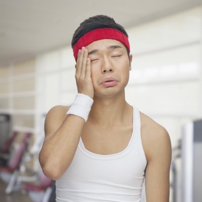 Portrait of tired young man at the gym