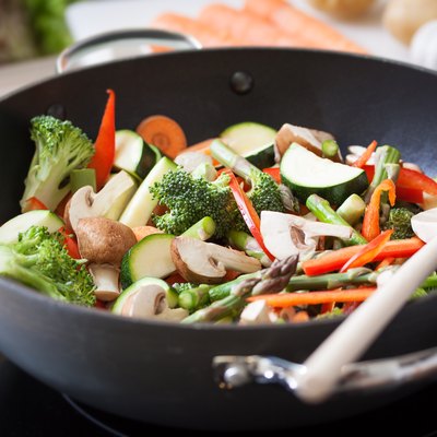 Wok stir fry vegetables with zucchini, spring asparagus, paprika