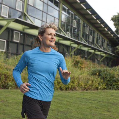 Fit Mature Woman Running Near Office Building