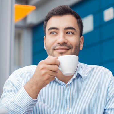 Coffee break, man resting with warmly drink