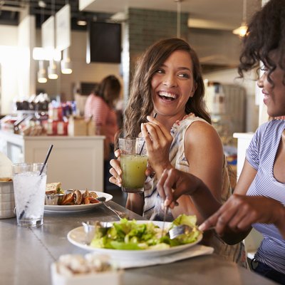 Two Women Enjoying Lunch Date In Delicatessen Restaurant