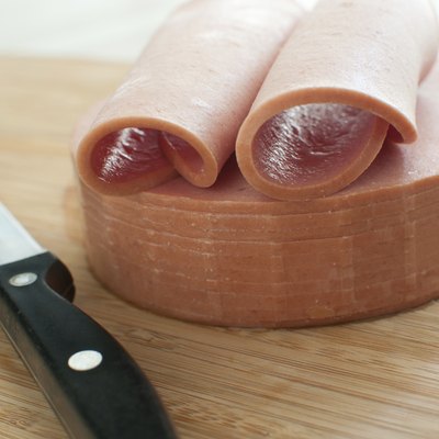 Sliced bologna sausage on cutting board