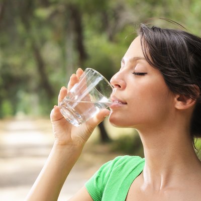 woman drinking water glass