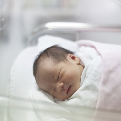 face of first day new born in hospital delivery room